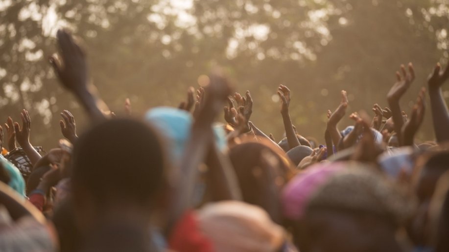 Raised hands in a crowd